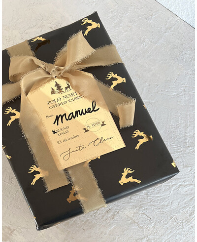 Papel de regalo negro con renos en oro